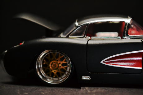 back end right side of red and black model corvette with trunk open